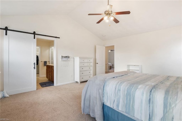 bedroom with lofted ceiling, ensuite bathroom, ceiling fan, a barn door, and light colored carpet