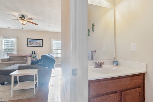 bathroom with vanity, ceiling fan, and wood-type flooring