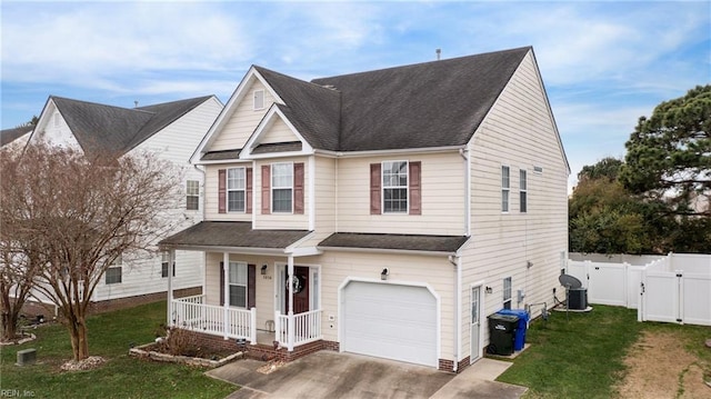 view of property with cooling unit, covered porch, a front yard, and a garage