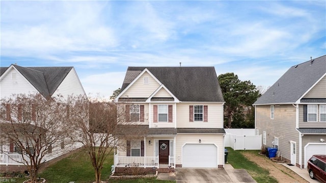 view of front of house with a front lawn, covered porch, and a garage