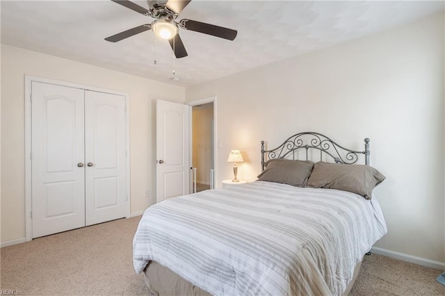 bedroom featuring ceiling fan, light carpet, and a closet