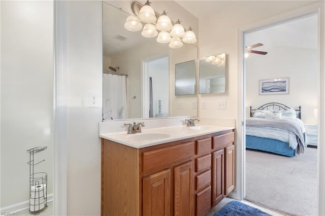 bathroom with curtained shower, ceiling fan, and vanity