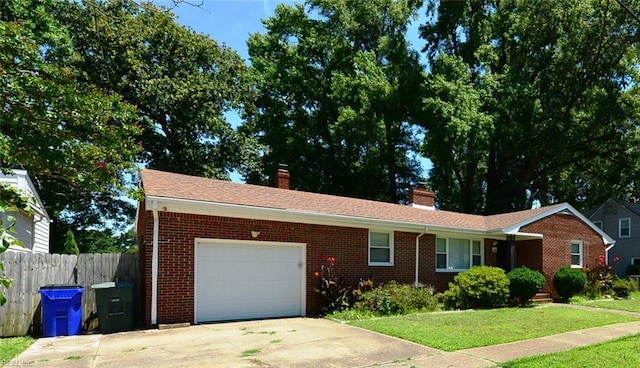 ranch-style home featuring a front yard and a garage