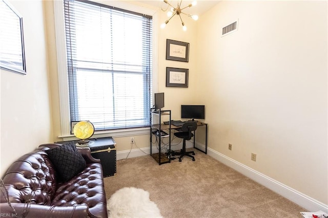 office with light carpet and an inviting chandelier