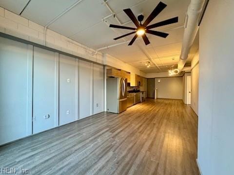 interior space featuring stainless steel fridge, light hardwood / wood-style flooring, and ceiling fan