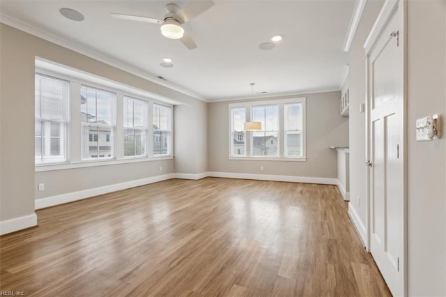 unfurnished living room with crown molding, plenty of natural light, ceiling fan, and light hardwood / wood-style floors