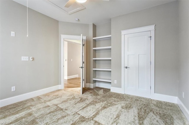 unfurnished bedroom featuring carpet and ceiling fan