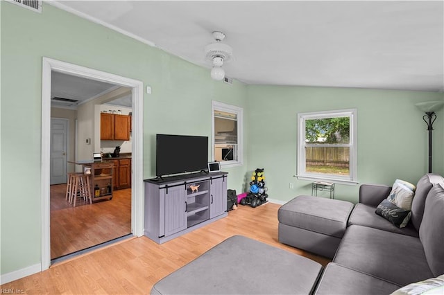 living room with lofted ceiling and light wood-type flooring