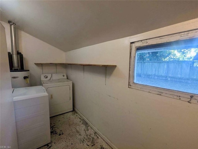 laundry area featuring strapped water heater