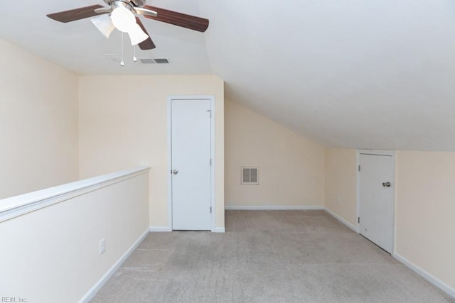 bonus room with ceiling fan, light colored carpet, and lofted ceiling