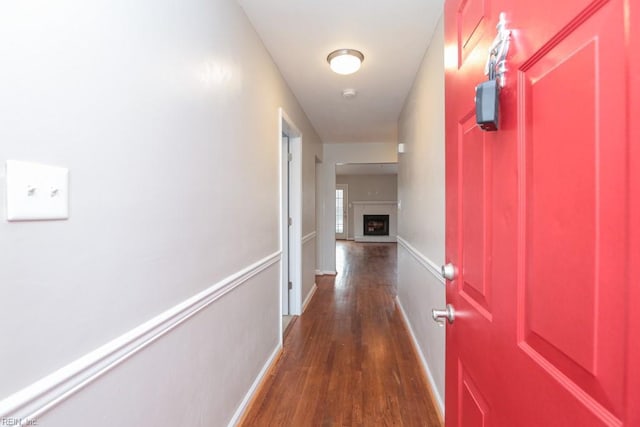 corridor with dark hardwood / wood-style flooring