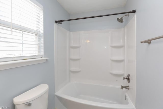 bathroom with shower / bath combination and toilet