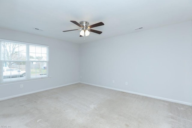 empty room featuring ceiling fan and light colored carpet