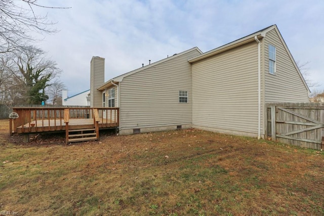 rear view of property featuring a deck