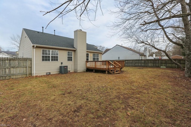 rear view of house with a deck, a yard, and central air condition unit