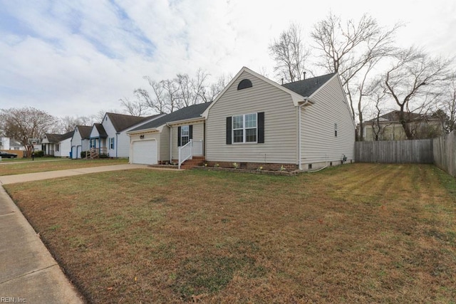 view of front of property featuring a front yard and a garage