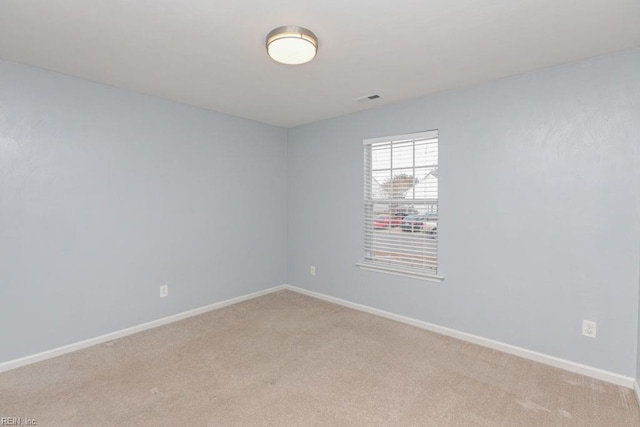 empty room featuring light colored carpet