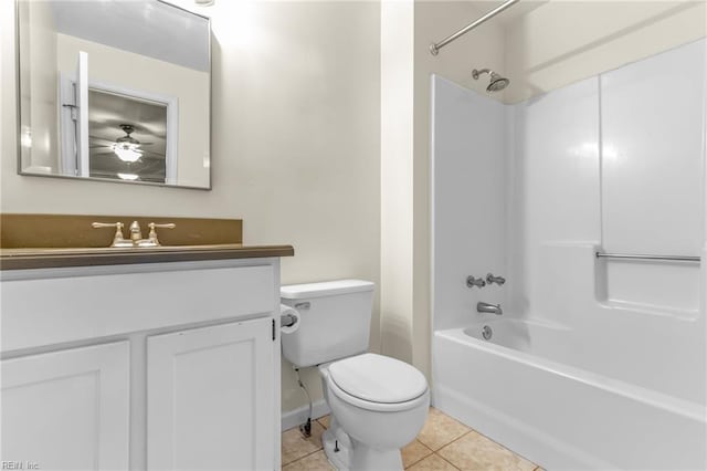 full bathroom with ceiling fan, tile patterned floors, toilet, vanity, and shower / bathtub combination