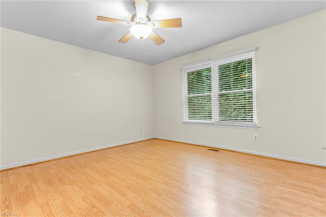 empty room featuring light wood-type flooring and ceiling fan