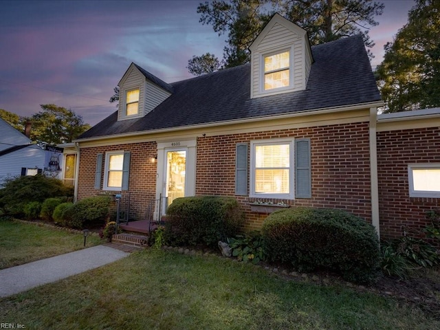 new england style home with a lawn