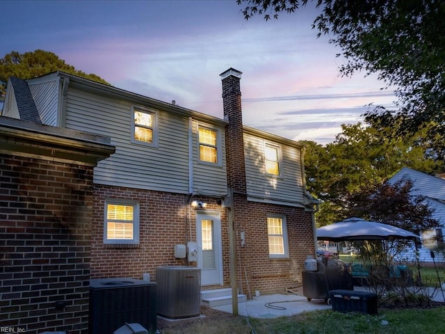 back house at dusk with central AC