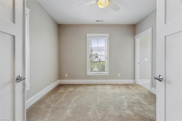 empty room with ceiling fan and light colored carpet