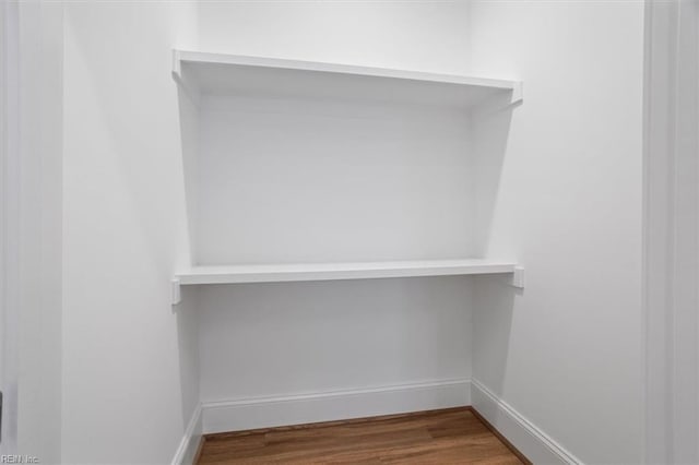 spacious closet featuring hardwood / wood-style flooring