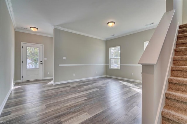 interior space featuring hardwood / wood-style flooring and crown molding