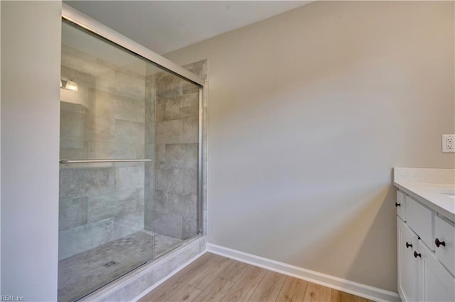 bathroom featuring vanity, wood-type flooring, and an enclosed shower