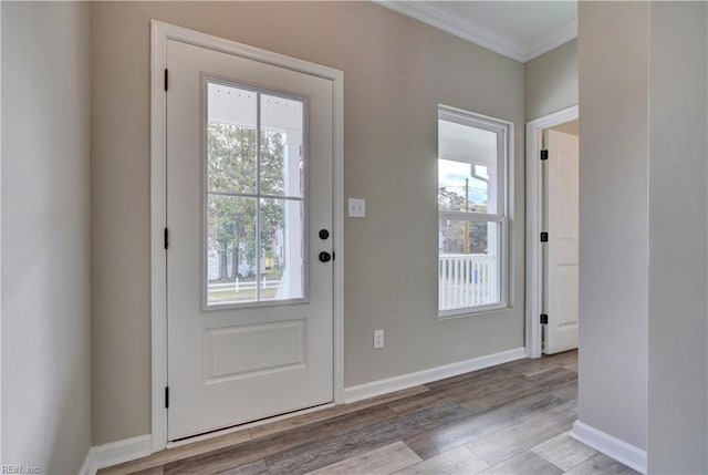 entryway with light hardwood / wood-style flooring and crown molding