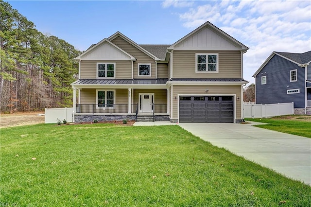 craftsman house with a front yard, a porch, and a garage