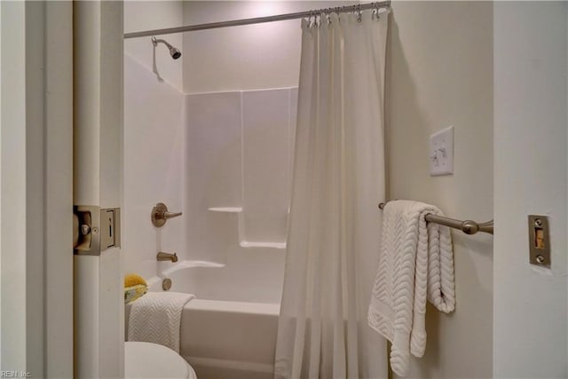 bathroom with toilet and shower / tub combo