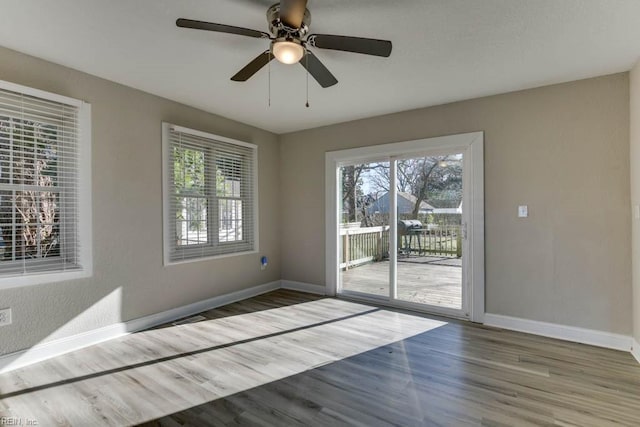 empty room featuring hardwood / wood-style flooring and ceiling fan