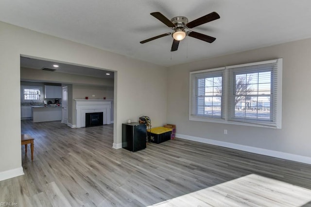 living room with light hardwood / wood-style floors and ceiling fan