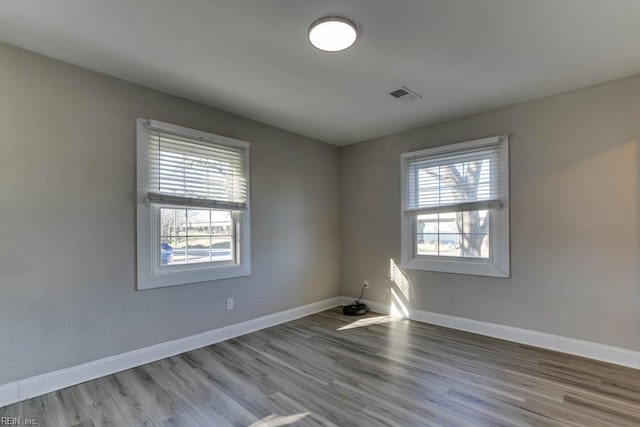 unfurnished room with light wood-type flooring