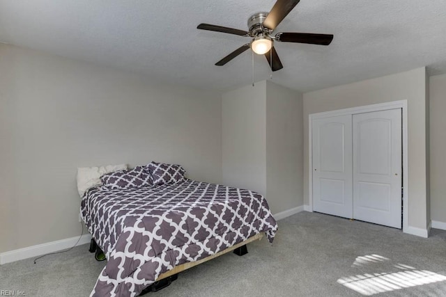 carpeted bedroom with a closet and ceiling fan