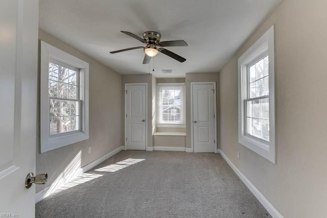 unfurnished room featuring light colored carpet and ceiling fan