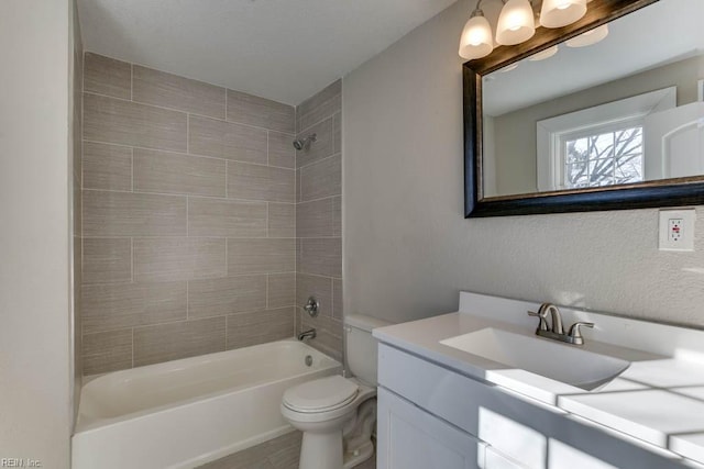 full bathroom with vanity, toilet, and tiled shower / bath