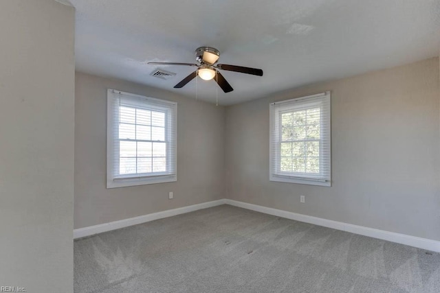 empty room featuring light carpet and ceiling fan