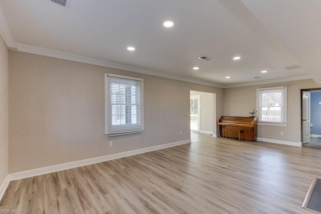 unfurnished living room with crown molding and light hardwood / wood-style flooring