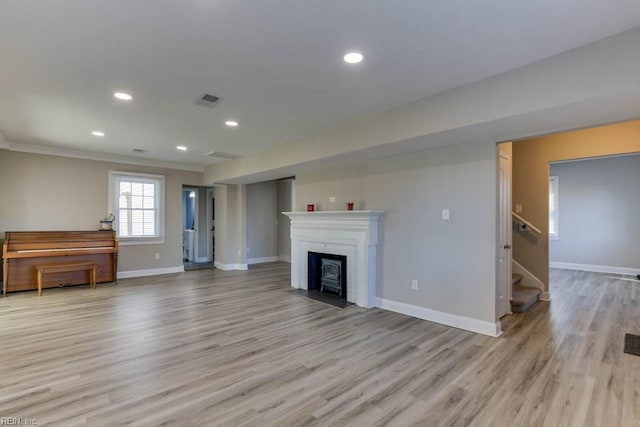 living room featuring a fireplace and light wood-type flooring