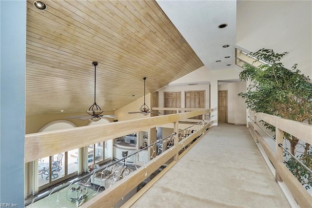 hall with wood ceiling and high vaulted ceiling