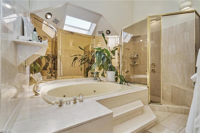 bathroom with tile patterned floors, lofted ceiling with skylight, and independent shower and bath