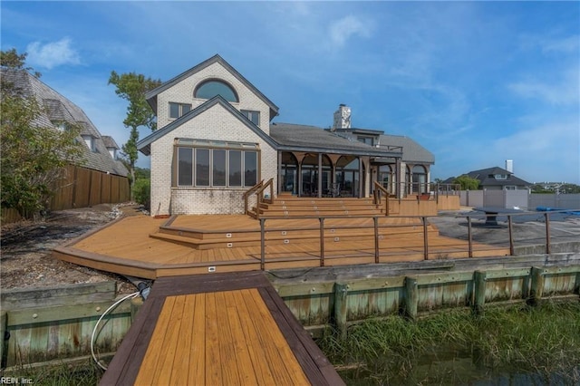 back of house featuring a wooden deck