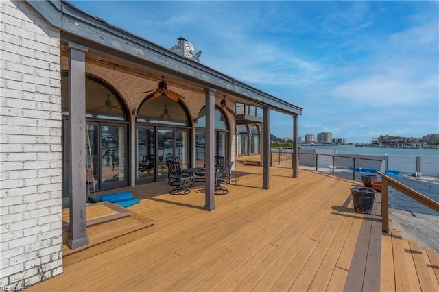 deck featuring a water view and ceiling fan