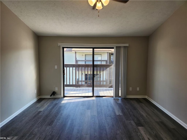 unfurnished room with ceiling fan, dark wood-type flooring, and a textured ceiling