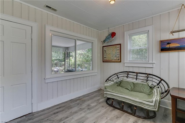 living area with wood-type flooring and plenty of natural light