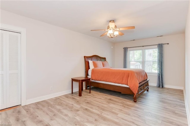 bedroom with ceiling fan, a closet, and light hardwood / wood-style floors