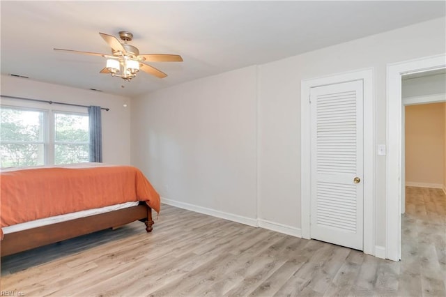 bedroom with ceiling fan and light hardwood / wood-style floors