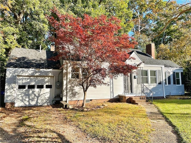 view of front of home featuring a garage and a front lawn